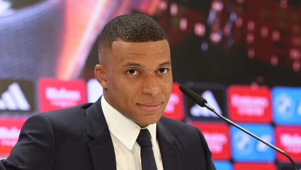 French forward Kylian Mbappe gives his first press conference as a Real Madrid player at the Santiago Bernabeu Stadium in Madrid on July 16, 2024, after signing his new five-season contract. Still celebrating Spain's Euro 2024 triumph, Real Madrid fans have even more to cheer this July 16, 2024, as French superstar Kylian Mbappe is officially presented to a packed-out Santiago Bernabeu stadium. (Photo by Pierre-Philippe MARCOU / AFP)