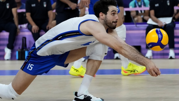 Daniele Lavia, of Italy, sets the ball during a semifinal men's volleyball match against France at the 2024 Summer Olympics, Wednesday, Aug. 7, 2024, in Paris, France. (AP Photo/Dolores Ochoa)