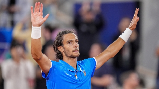 Lorenzo Musetti of Italy reacts after defeating Felix Auger-Aliassime of Canada during men's singles bronze medal tennis match at the Roland Garros stadium, at the 2024 Summer Olympics, Saturday, Aug. 3, 2024, in Paris, France. (AP Photo/Manu Fernandez)