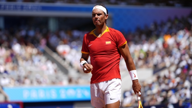 Spain's Rafael Nadal walks backs as he plays Serbia's Novak Djokovic during their men's singles second round match at the 2024 Summer Olympics, Monday, July 29, 2024, at the Roland Garros stadium in Paris, France. (AP Photo/Manu Fernandez)    Associated Press / LaPresse Only italy and Spain