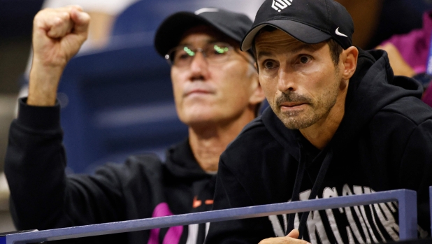 Italy's Jannik Sinner's Australian coach Darren Cahill (L) and Italian coach Simone Vagnozzi (R) watch him play against Russia's Daniil Medvedev during their men's quarterfinals match on day ten of the US Open tennis tournament at the USTA Billie Jean King National Tennis Center in New York City, on September 4, 2024. (Photo by Kena Betancur / AFP)