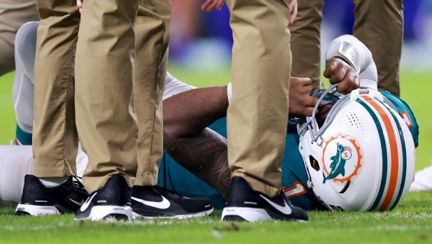 MIAMI GARDENS, FLORIDA - SEPTEMBER 12: Tua Tagovailoa #1 of the Miami Dolphins lays on the ground after colliding with Damar Hamlin #3 of the Buffalo Bills during the third quarter in the game at Hard Rock Stadium on September 12, 2024 in Miami Gardens, Florida.   Carmen Mandato/Getty Images/AFP (Photo by Carmen Mandato / GETTY IMAGES NORTH AMERICA / Getty Images via AFP)