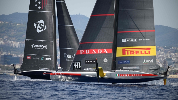 Italia's Luna Rossa Prada Pirelli and US NYYC American Magic compete on the third day of the 37th America's Cup-Luis Vuitton preliminary regatta, off the coast of Barcelona on August 31, 2024. (Photo by Josep LAGO / AFP)