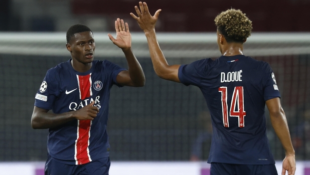 epa11612873 Nuno Mendes (L) and Desire Doue of PSG celebrate the 1-0 goal during the UEFA Champions League soccer match between Paris Saint-Germain and Girona FC in Paris, France, 18 September 2024.  EPA/YOAN VALAT