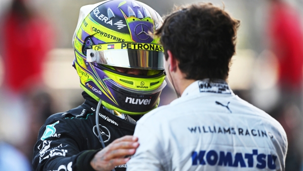 BAKU, AZERBAIJAN - SEPTEMBER 15: 9th placed Lewis Hamilton of Great Britain and Mercedes talks with 8th placed Franco Colapinto of Argentina and Williams in parc ferme during the F1 Grand Prix of Azerbaijan at Baku City Circuit on September 15, 2024 in Baku, Azerbaijan. (Photo by Rudy Carezzevoli/Getty Images)