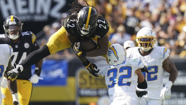 Pittsburgh Steelers running back Najee Harris (22) tries to hurdle Los Angeles Chargers safety Alohi Gilman (32) during the second half of an NFL football game, Sunday, Sept. 22, 2024, in Pittsburgh. (AP Photo/Matt Freed)