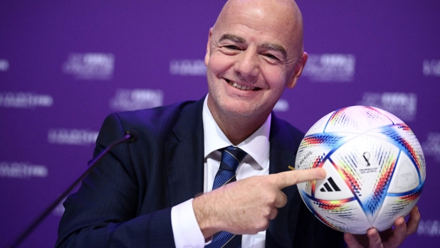 TOPSHOT - FIFA president Gianni Infantino poses with Al Rihla, the official match ball before a press conference during the 72th FIFA Congress in the Qatari capital Doha, on March 31, 2022. - The countdown towards the most controversial World Cup in history really begins tomorrow as the draw for Qatar 2022 takes place in Doha 2022, less than eight months befor the start of the tournament itself. (Photo by FRANCK FIFE / AFP)