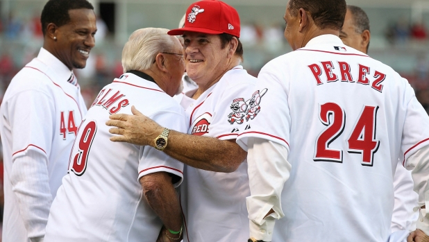 (FILES) Pete Rose hugs Tommy Helms during the ceremony celebrating the 25th anniversary of his breaking the career hit record of 4,192 on September 11, 2010 at Great American Ball Park in Cincinnati, Ohio. Pete Rose, Major League Baseball's all-time hit king who left the sport in disgrace after being banned for betting on games, died on September 30, 2024 aged 83, multiple US media outlets reported. Nicknamed "Charlie Hustle" for his hard-charging effort and dogged determination, the long-time hometown hero for the Cincinnati Reds passed away in Las Vegas, reports said. (Photo by ANDY LYONS / GETTY IMAGES NORTH AMERICA / AFP)