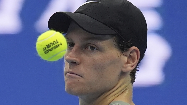 Jannick Sinner of Italy tosses a ball as he waits for play against Roman Safiullin of Russia during the China Open tennis tournament held at the National Tennis Center in Beijing, Saturday, Sept. 28, 2024. (AP Photo/Ng Han Guan)