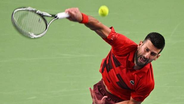 Serbia's Novak Djokovic serves against Italy's Flavio Cobolli during their men's singles match at the Shanghai Masters tennis tournament in Shanghai on October 8, 2024. (Photo by HECTOR RETAMAL / AFP)