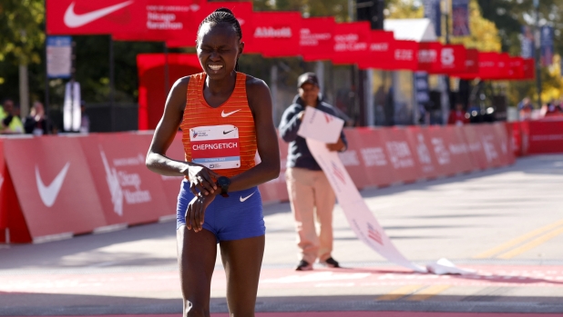 Kenya's Ruth Chepngetich reacts after crossing the finish line to place first in the women's division of the 2022 Bank of America Chicago Marathon in Chicago, Illinois, on October 9, 2022. (Photo by KAMIL KRZACZYNSKI / AFP)