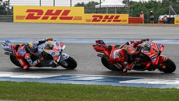 Ducati Lenovo Team's Italian rider Francesco Bagnaia rides in front of Gresini Racing MotoGP's Spanish rider Marc Marquez (L) during the MotoGP Thailand Grand Prix at the Buriram International Circuit in Buriram on October 27, 2024. (Photo by Lillian SUWANRUMPHA / AFP)