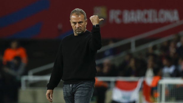 Barcelona's head coach Hansi Flick gives instructions to his players during a Spanish La Liga soccer match between Barcelona and Sevilla at the Olimpic Lluis Companys stadium in Barcelona, Spain, Sunday, Oct. 20, 2024. (AP Photo/Joan Monfort)