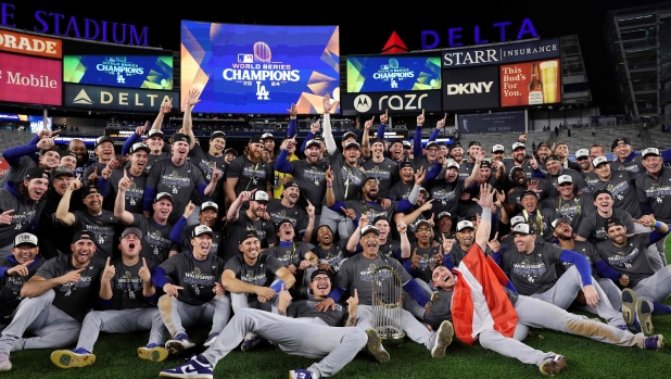 NEW YORK, NEW YORK - OCTOBER 30: The Los Angeles Dodgers pose on the field after defeating the New York Yankees 7-6 in game 5 to win the 2024 World Series at Yankee Stadium on October 30, 2024 in the Bronx borough of New York City.   Elsa/Getty Images/AFP (Photo by ELSA / GETTY IMAGES NORTH AMERICA / Getty Images via AFP)