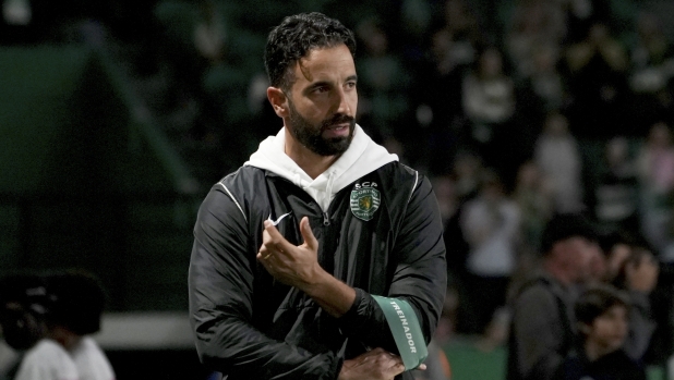 Sporting's head coach Ruben Amorim, who Manchester United has expressed an interest in hiring, adjusts his coach armband during a Portuguese League Cup soccer match between Sporting CP and Nacional at the Alvalade stadium in Lisbon, Tuesday, Oct. 29, 2024. (AP Photo/Ana Brigida)