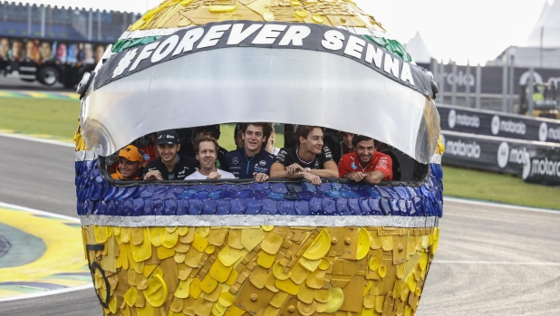 epa11694991 Formula One drivers pose inside a helmet made from recycled materials as part of this year's commemorative events to mark the 30th anniversary of the death of Brazilian triple world champion Ayrton Senna, at the Interlagos circuit in Sao Paulo, Brazil, 31 October 2024. Hamilton announced that he will drive Ayrton Senna's iconic McLaren MP4/5B on the Interlagos circuit on 02 November. 'I never in a million years thought I would be driving Senna's car here. It will be an exciting experience. I hope people enjoy it,' he said. The GP of Sao Paulo takes place on 03 November.  EPA/SEBASTIAO MOREIRA