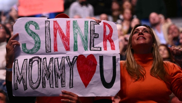 Italy's Jannik Sinner supporters cheer in the stands during his match against USA's Taylor Fritz at the ATP Finals tennis tournament in Turin on November 12, 2024. (Photo by Marco BERTORELLO / AFP)