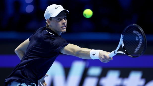 TURIN, ITALY - NOVEMBER 12: Jannik Sinner of Italy plays a backhand against Taylor Fritz of United States in the Men's Singles Ilie Nastase Group Stage match during day three of the Nitto ATP finals 2024 at Inalpi Arena on November 12, 2024 in Turin, Italy. (Photo by Clive Brunskill/Getty Images)