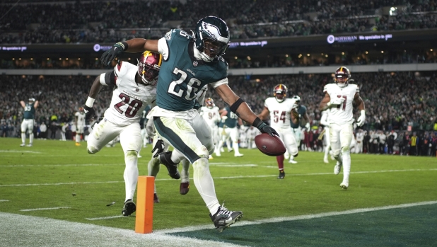 Philadelphia Eagles running back Saquon Barkley (26) scores during the second half of an NFL football game against the Washington Commanders Thursday, Nov. 14, 2024, in Philadelphia. (AP Photo/Matt Slocum)