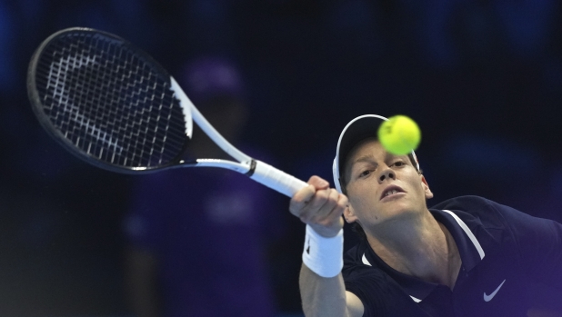 Italy's Jannik Sinner returns the ball to Russia's Daniil Medvedev during their singles tennis match of the ATP World Tour Finals at the Inalpi Arena, in Turin, Italy, Thursday, Nov. 14, 2024. (AP Photo/Antonio Calanni)