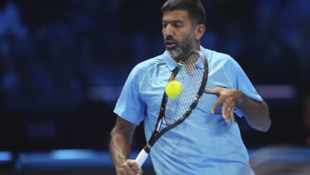 India's Rohan Bopanna returns the ball with his teammate Australia's Matthew Ebden to Italy's Simone Bolelli and Andrea Vavassori during their doubles tennis match of the ATP World Tour Finals at the Inalpi Arena, in Turin, Italy, Monday, Nov. 11, 2024. (AP Photo/Antonio Calanni)