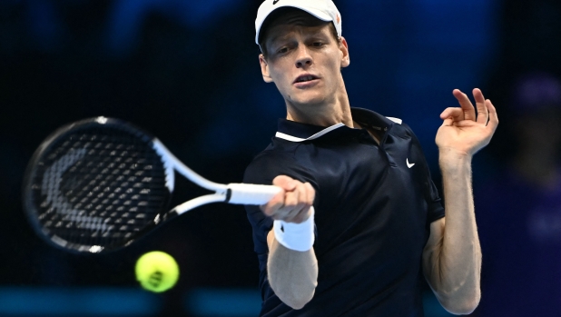 Italy's Jannik Sinner hits a return to Norway's Casper Ruud during their semi-final match at the ATP Finals tennis tournament in Turin on November 16, 2024. (Photo by Marco BERTORELLO / AFP)