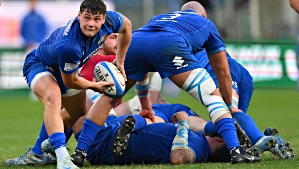 Italy's scrum half Alessandro Garbisi (L) clears the ball during the Autumn Nations Series International rugby union test match between Italy and Georgia at the Luigi Ferraris stadium in Genoa, on November 17, 2024. (Photo by Andreas SOLARO / AFP)