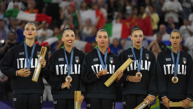 Team Italy poses for a photograph after winning the bronze medal in the group all-around rhythmic gymnastics at La Chapelle Arena during the 2024 Summer Olympics, Saturday, Aug. 10, 2024, in Paris, France. (AP Photo/Dar Yasin)