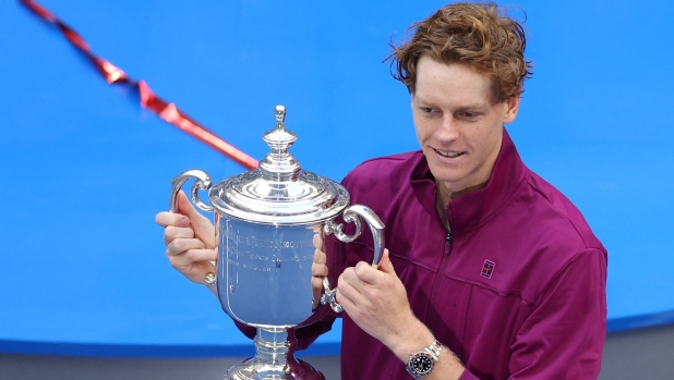 Italy's Jannik Sinner poses with the trophy after winning his men's final match against USA's Taylor Fritz on day fourteen of the US Open tennis tournament at the USTA Billie Jean King National Tennis Center in New York City, on September 8, 2024. (Photo by CHARLY TRIBALLEAU / AFP)