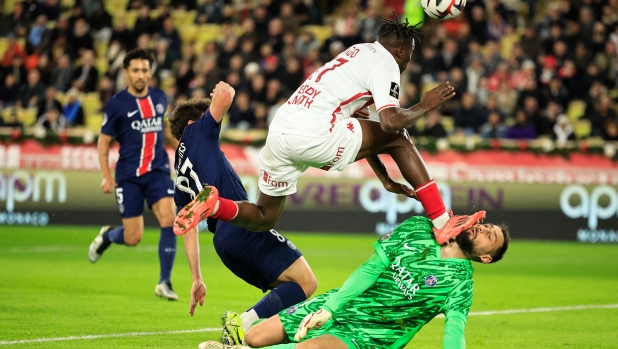 Paris Saint-Germain's Italian goalkeeper #01 Gianluigi Donnarumma sustains an injury by Monaco's Ivorian defender #17 Wilfried Singo (2nd-R) during the French L1 football match between AS Monaco and Paris Saint-Germain at the Louis II Stadium (Stade Louis II) in the Principality of Monaco on December 18, 2024. (Photo by Valery HACHE / AFP)