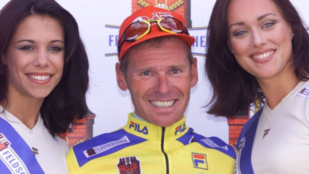 French racer Pascal Herve from Team Polti, center, smiles between the former Moss Switzerland Sonia Grabdjean, left and Tania Gutmann, wearing the yellow jersey of the overall leader, after winning the fourth stage of the bicycle tour race Tour de Suisse, Friday, June 16, 2000 in Verbier, Switzerland. The stage led from Fribourg to Verbier.  (AP Photo/Alessandro della Valle)  === ELECTRONIC IMAGE===