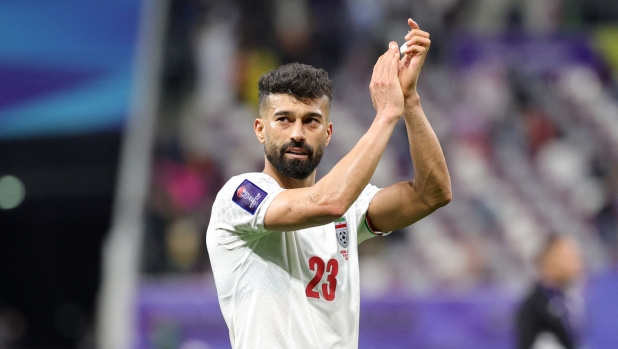 Iran's defender #23 Ramin Rezaeian reacts after the Qatar 2023 AFC Asian Cup Group C football match between Hong Kong and Iran at the Khalifa International Stadium in Doha on January 19, 2024. (Photo by Giuseppe CACACE / AFP)