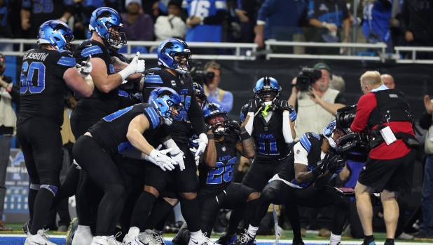 DETROIT, MICHIGAN - JANUARY 05: Jahmyr Gibbs #26 of the Detroit Lions celebrates a touchdown with teammates during the fourth quarter against the Minnesota Vikings at Ford Field on January 05, 2025 in Detroit, Michigan.   Mike Mulholland/Getty Images/AFP (Photo by Mike Mulholland / GETTY IMAGES NORTH AMERICA / Getty Images via AFP)