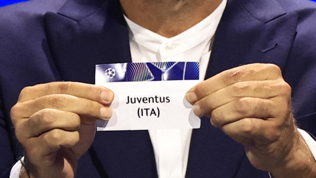 Italy's former goalkeeper Gianluigi Buffon shows the paper slip of Juventus (ITA) during the group stage of the 2024-2025 UEFA Champions League football tournament, at the Grimaldi Forum in Monaco on August 29, 2024. (Photo by Valery HACHE / AFP)