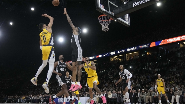 Indiana Pacers guard Tyrese Haliburton (0) shoots over San Antonio Spurs forward Jeremy Sochan (10) during the first half of a Paris Games 2025 NBA basketball game in Paris, Saturday, Jan. 25, 2025. (AP Photo/Thibault Camus)