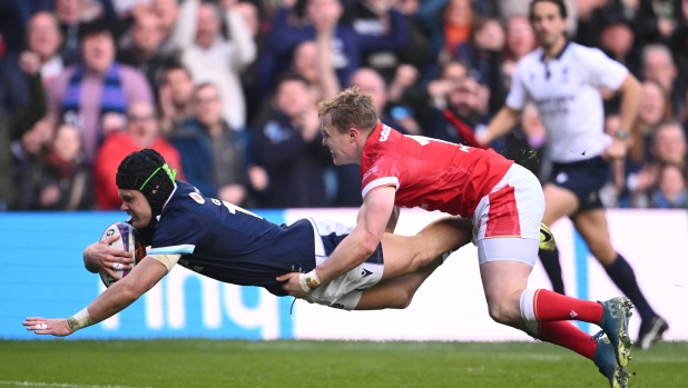 EDINBURGH, SCOTLAND - MARCH 08: Darcy Graham of Scotland dives over to score the third Scotland try despite the tackle of Blair Murray of Wales during the Guinness Six Nations 2025 match between Scotland and Wales at Scottish Gas Murrayfield on March 08, 2025 in Edinburgh, Scotland. (Photo by Stu Forster/Getty Images)