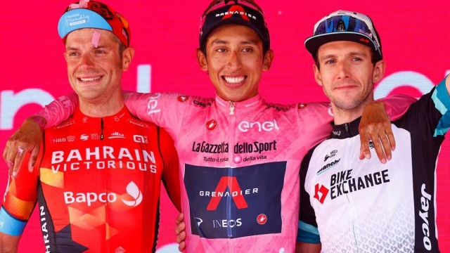 (From L) Overall second-placed Team Bahrain rider Italy's Damiano Caruso, Giro d'Italia 2021 winner Team Ineos rider Colombia's Egan Bernal and third-placed Team BikeExchange rider Great Britain's Simon Yates celebrate on the podium after the 21st and last stage on May 30, 2021 in Milan. (Photo by Luca Bettini / AFP)