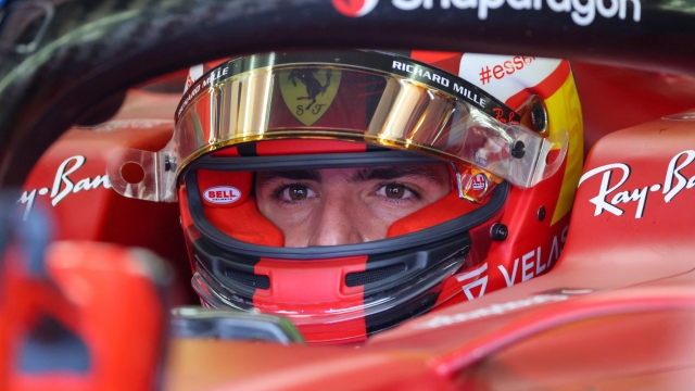 Ferrari's Spanish driver Carlos Sainz Jr sits in his car during the third day of Formula One (F1) pre-season testing at the Bahrain International Circuit in the city of Sakhir on March 12, 2022. (Photo by Giuseppe CACACE / AFP)