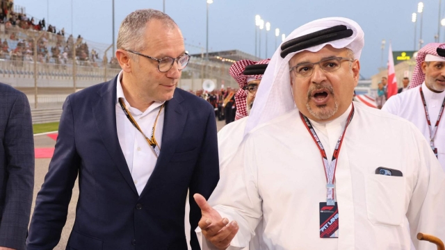 Stefano Domenicali (C) , CEO of the Formula One Group walks next to President of the International Automobile Federation (FIA) Mohammed ben Sulayem (L) prior the Bahrain Formula One Grand Prix at the Bahrain International Circuit in the city of Sakhir on March 20, 2022. (Photo by Giuseppe CACACE / POOL / AFP)