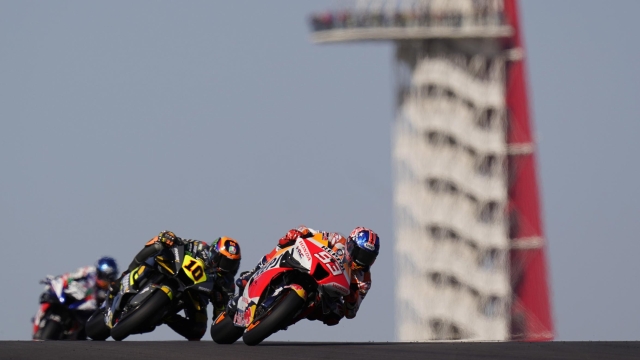 Marc Marquez (93), of Spain, leads Luca Marini (10), of Italy, through a turn during an open practice session for the MotoGP Grand Prix of the Americas motorcycle race at the Circuit of the Americas, Saturday, April 9, 2022, in Austin, Texas. (AP Photo/Eric Gay)