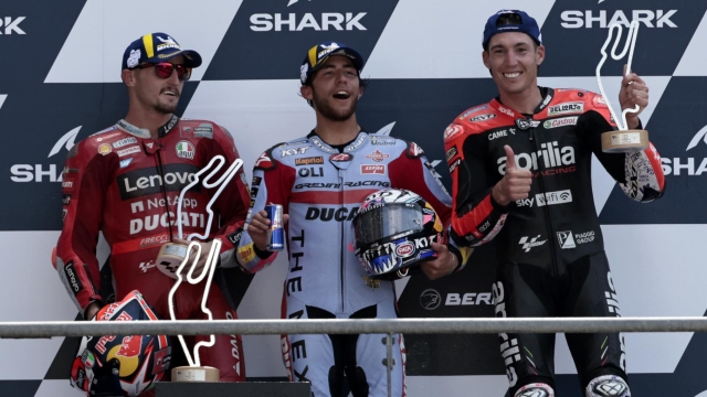 Race winner, Italian rider Enea Bastianini of the Gresini Racing MotoGP, center, poses with second placed Australian rider Jack Miller of the Ducati Lenovo Team, left, and third placed Spain's rider Aleix Espargaro of the Aprilia Racing after the MotoGP race of the French Motorcycle Grand Prix at the Le Mans racetrack, in Le Mans, France, Sunday, May 15, 2022. (AP Photo/Jeremias Gonzalez)