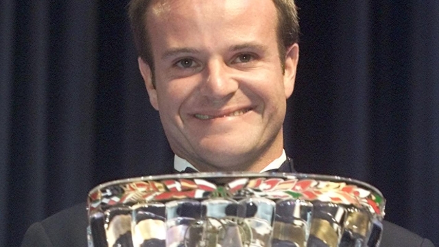 Brazilian formula one driver Rubens Barrichello holds his FIA Formula One World Championship's trophy for the third place, during the 2001 FIA Prize Giving Gala in Monaco, Friday Dec. 14, 2001. (Ap Photo/Lionel Cironneau/Pool)