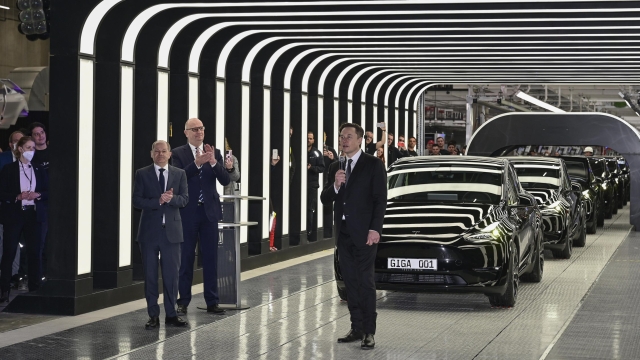 German Chancellor Olaf Scholz, Dietmar Woidke, Minister President of the State of Brandenburg, and Elon Musk, Tesla CEO, from left, attend the opening of the Tesla factory Berlin Brandenburg in Gruenheide, Germany, Tuesday, March 22, 2022. The first European factory in Gr'nheide, designed for 500,000 vehicles per year, is an important pillar of Tesla's future strategy. (Patrick Pleul/Pool via AP)