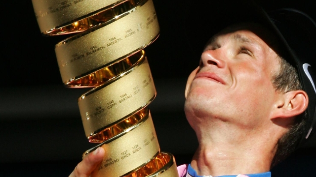 Italy's Paolo Savoldelli looks at the overall leader's cup he won at the end of the Giro, Tour of Italy cycling race, in Milan, Italy, Sunday, May 29, 2005. (AP Photo/Andrew Medichini)