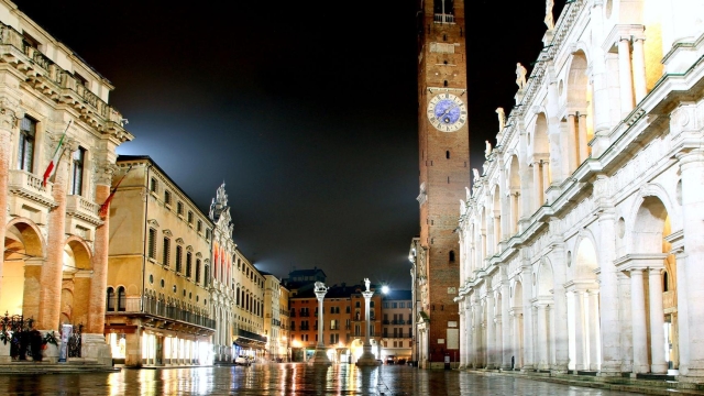 Main city square and palladian basilica with tower at night in Vicenza Italy