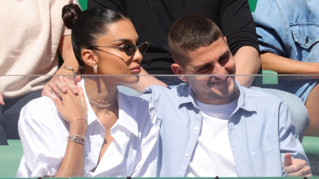 Paris Saint-Germain's Italian football player Marco Verratti sits next to his wife Jessica Aidi Verratti,during the Monte-Carlo ATP Masters Series tournament in Monaco on April 11, 2022. (Photo by Valery HACHE / AFP)