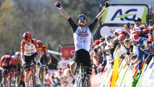 Slovenian Tadej Pogacar of UAE Team Emirates celebrates as he crosses the finish line to win the 86th edition of the men's race "La Fleche Wallonne", a one day cycling race (Waalse Pijl - Walloon Arrow), 194,2 km from Herve to Huy, in Belgium, on April 19, 2023 (Photo by GOYVAERTS / BELGA / AFP) / Belgium OUT