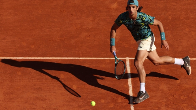 MONTE-CARLO, MONACO - APRIL 14: Lorenzo Musetti of Italy runs to play a forehand volley against Jannik Sinner of Italy in their quarterfinal match during day six of the Rolex Monte-Carlo Masters at Monte-Carlo Country Club on April 14, 2023 in Monte-Carlo, Monaco. (Photo by Clive Brunskill/Getty Images)