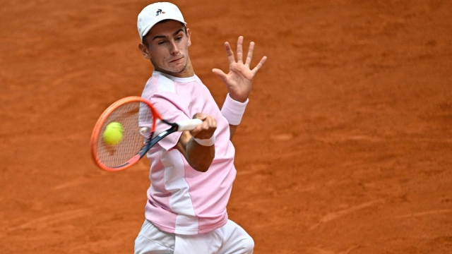 Italy's Matteo Arnaldi returns the ball to Norway's Casper Ruud during their 2023 ATP Tour Madrid Open tennis tournament singles match at the Caja Magica in Madrid on April 28, 2023. (Photo by JAVIER SORIANO / AFP)