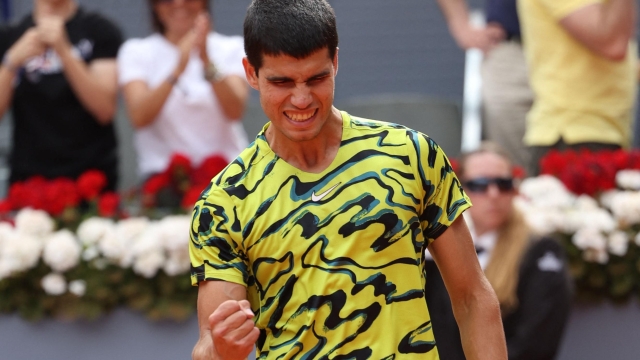 Spain's Carlos Alcaraz celebrates beating Germany's Alexander Zverev during their 2023 ATP Tour Madrid Open tennis tournament singles match at Caja Magica in Madrid on May 2, 2023. (Photo by Thomas COEX / AFP)